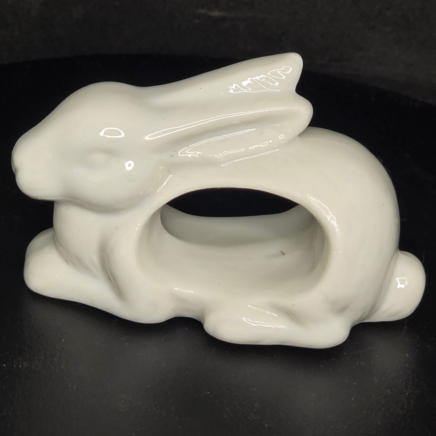 Close-up of vintage Japan porcelain bunny napkin ring showing cream glazed finish