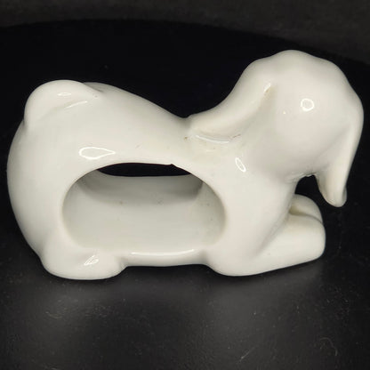Side view of vintage animal napkin ring set showing three-dimensional sculpting