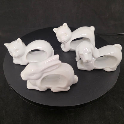 Set of four vintage porcelain animal napkin rings from Japan featuring bunny, bear, puppy, and kitty cat