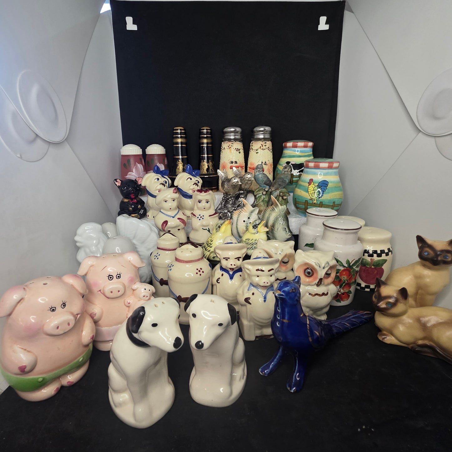 Overview of vintage salt and pepper shaker collection showing variety of styles and eras