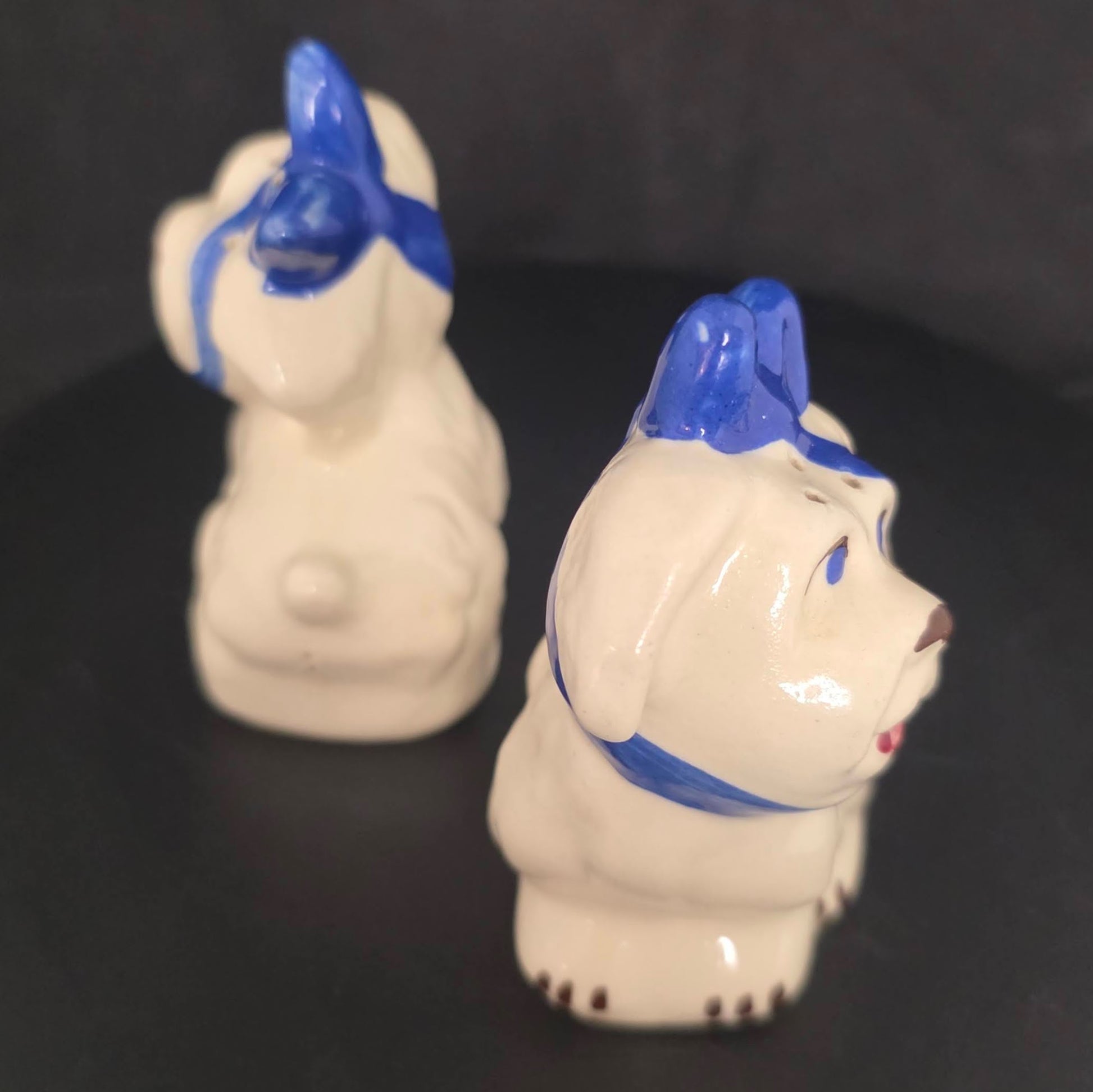 Side view of Shawnee Pottery Mugsy dog shakers showing glazed ceramic finish