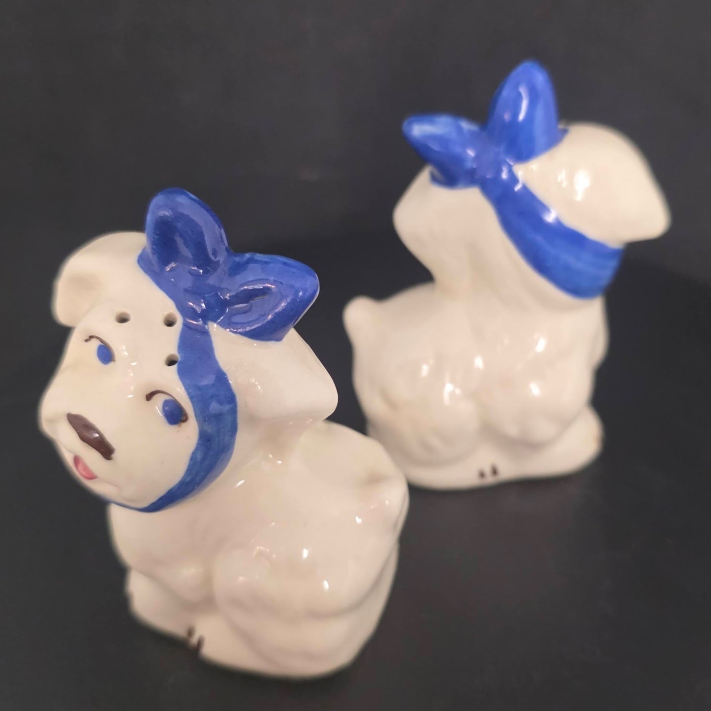 Front and back view of vintage Mugsy dog shakers in excellent condition