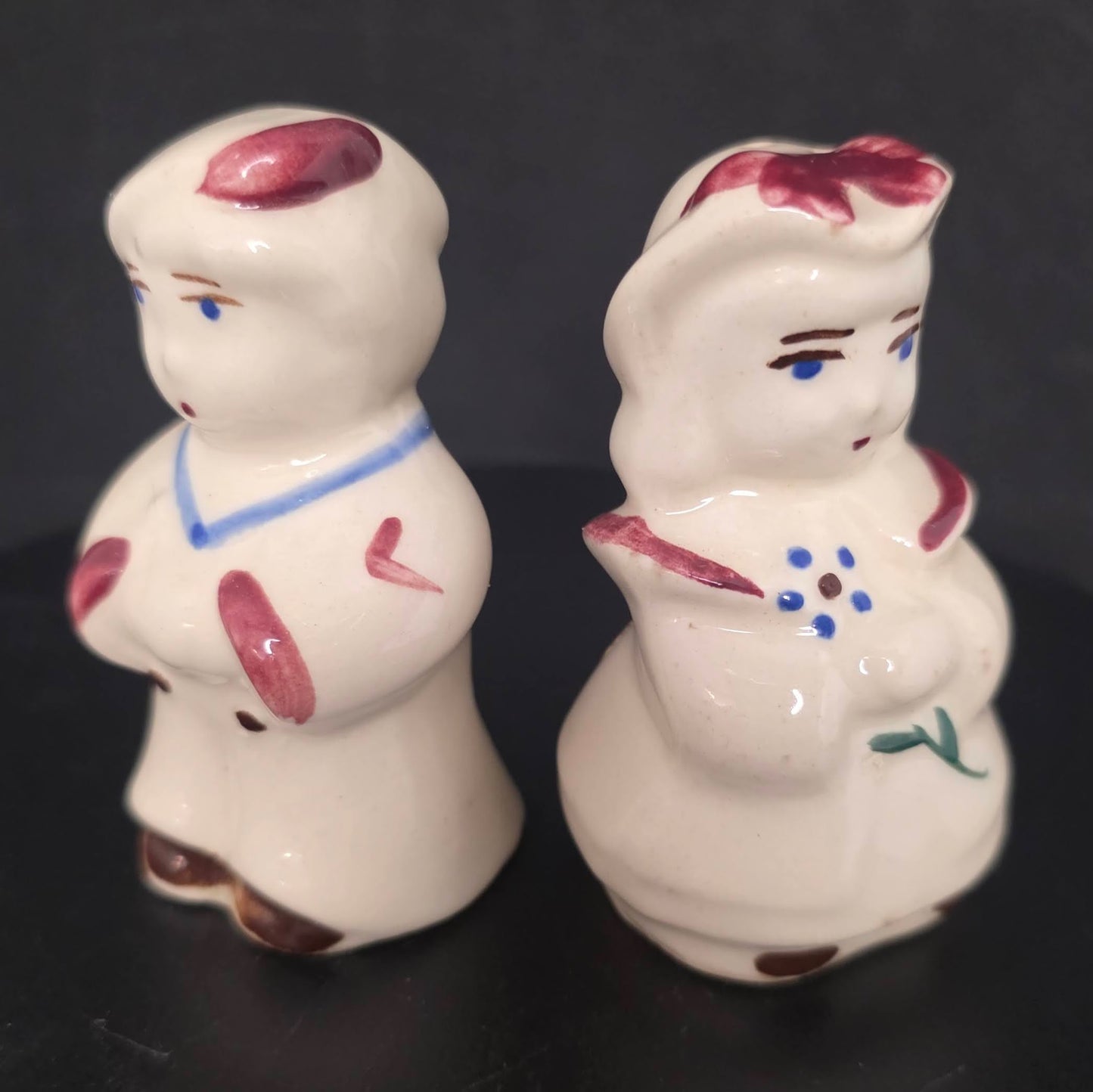 Front view of vintage nursery rhyme character shakers, circa 1940s-1950s