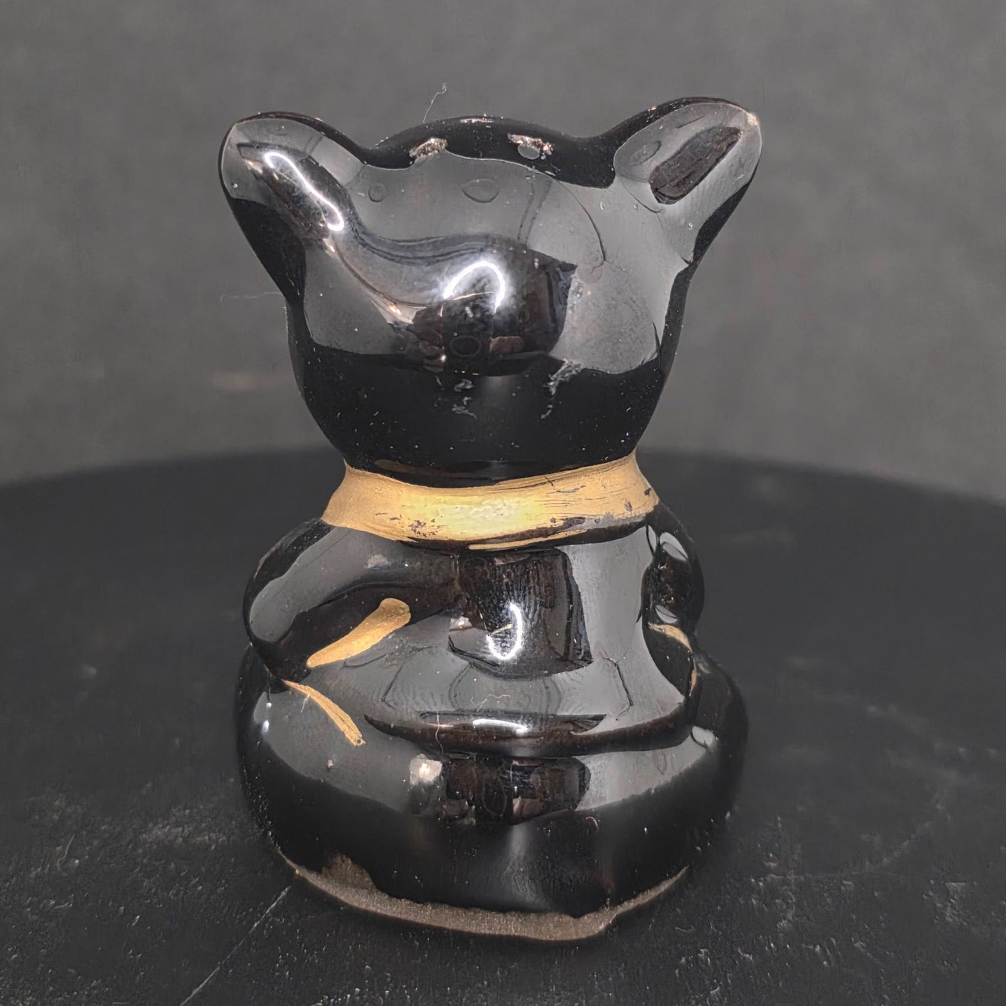 Back view of single black pig shaker, 2.75 inches tall, no stopper