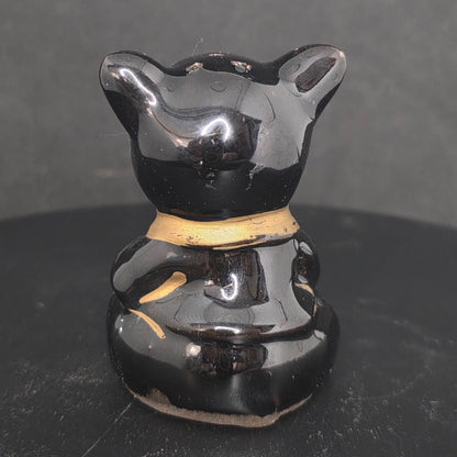 Back view of single black pig shaker, 2.75 inches tall, no stopper