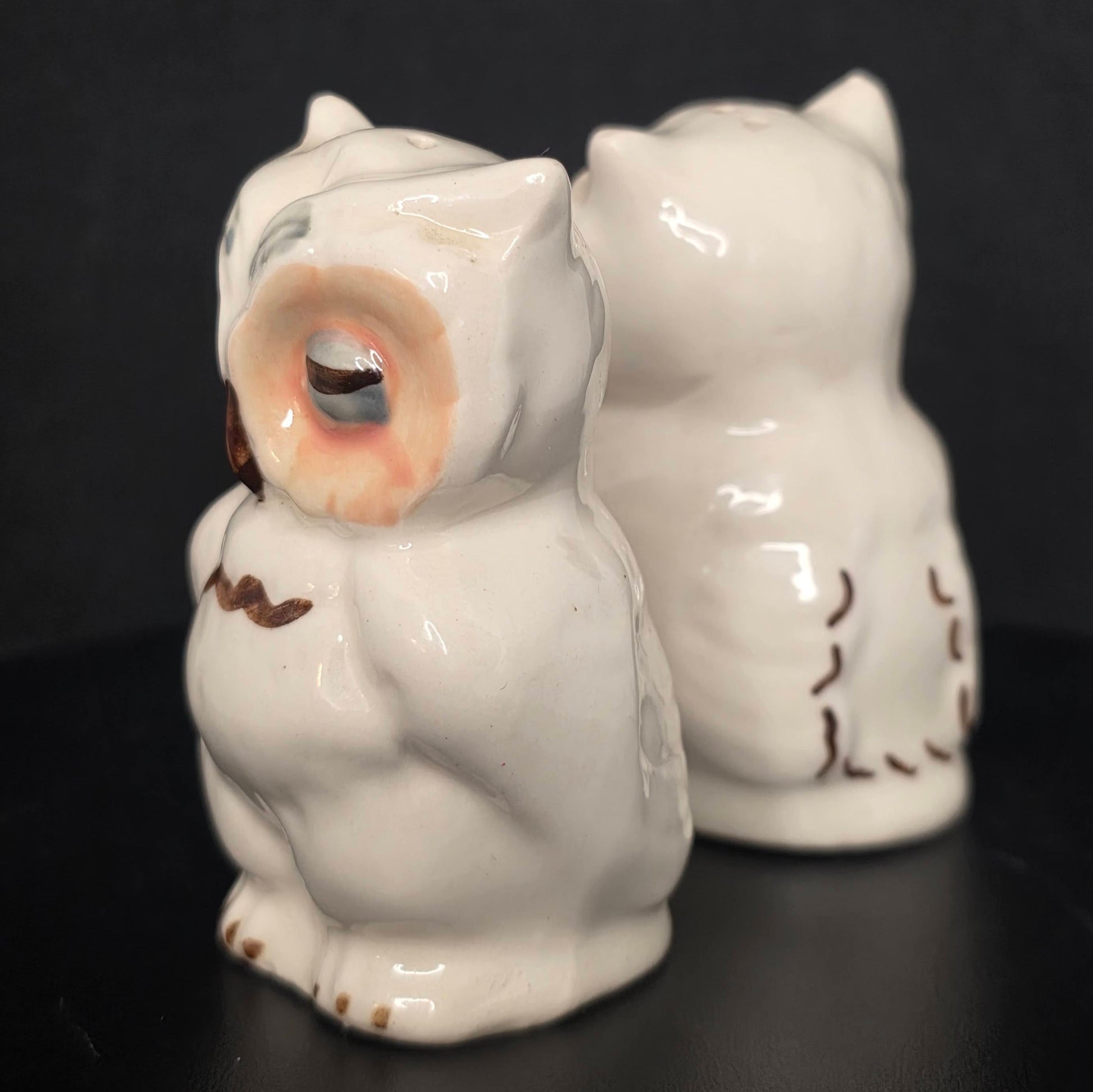 Side view of Shawnee Pottery owl shakers, glazed ceramic