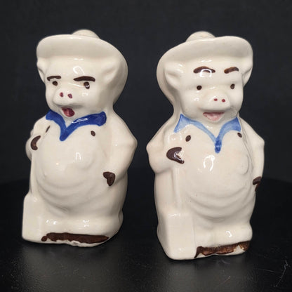 Front view of vintage farmer pig shakers in excellent condition