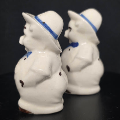 Side view of Shawnee Pottery farmer pig shakers, glazed ceramic