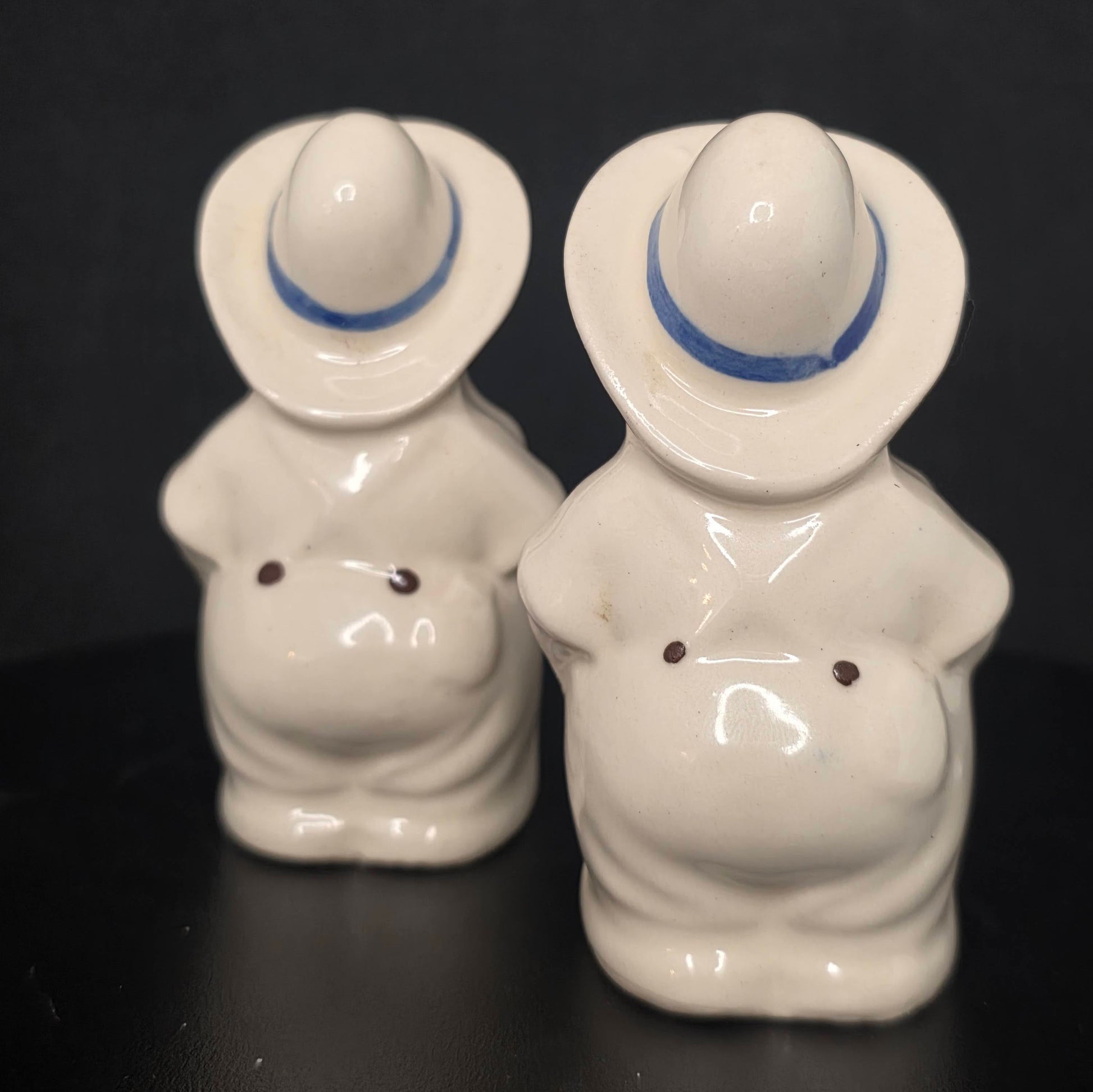 Back view of farmer pig shakers showing Shawnee Pottery details