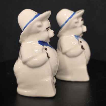 Side view of Shawnee Pottery farmer pig shakers, glazed ceramic