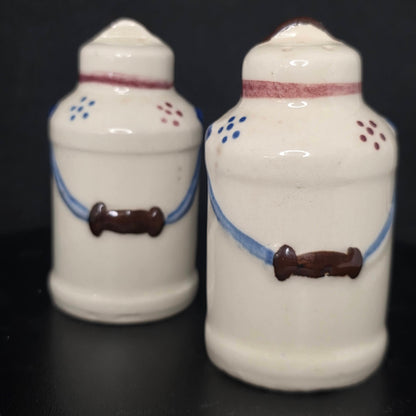 Front view of vintage milk can shakers in excellent condition