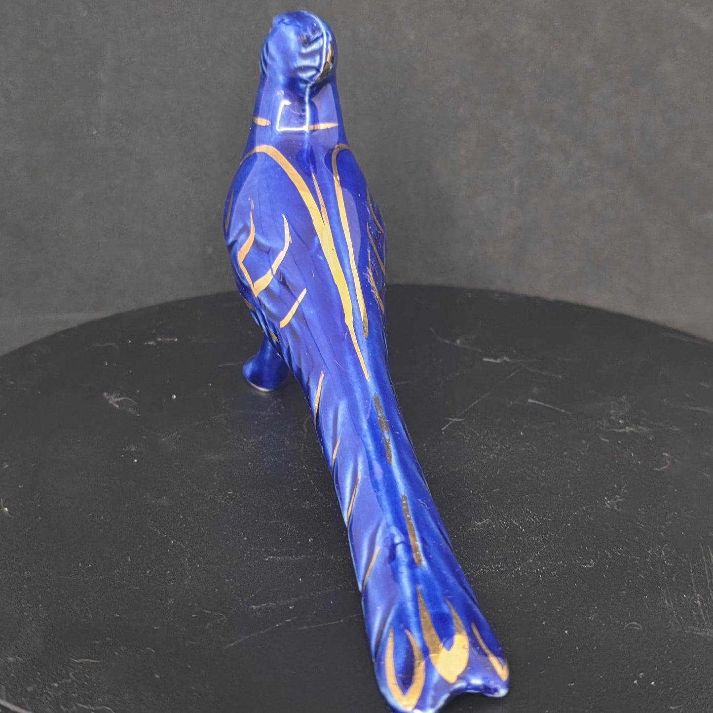 Detail of gold accent details on vintage pheasant shaker, 7 inches long with stopper