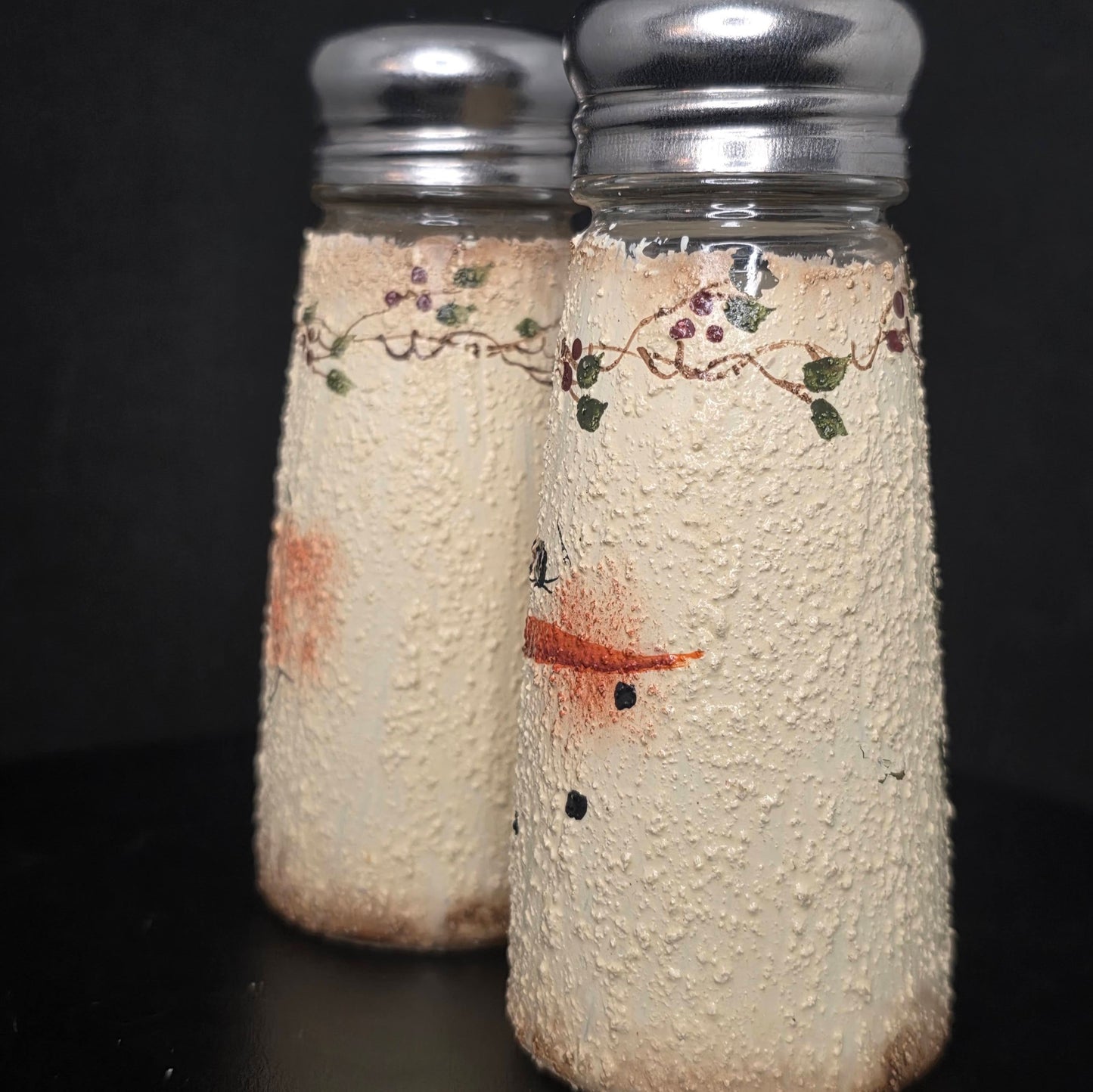 Close-up of textured snowman shaker showing hand-painted details