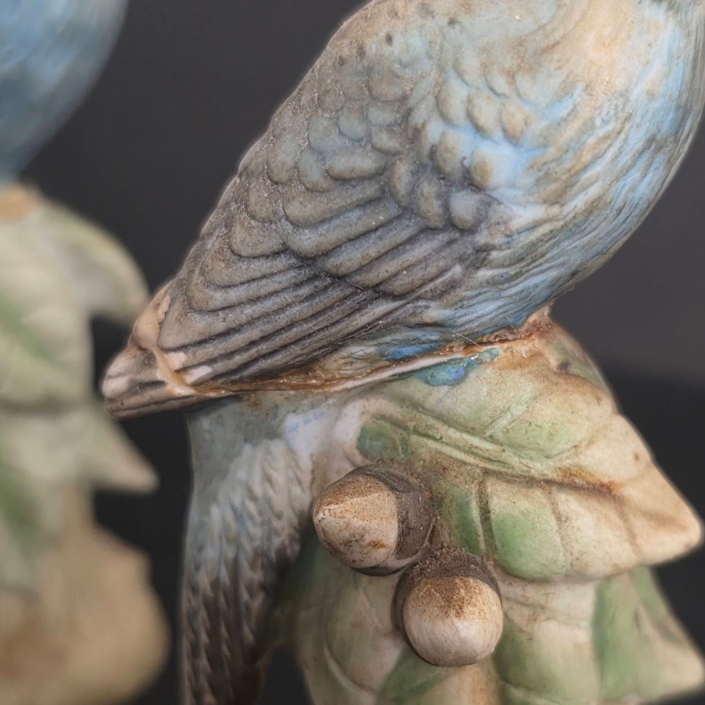 Detail of repair on vintage blue parakeet shaker