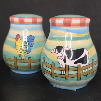 Front view of vibrant glazed ceramic cow and rooster shakers