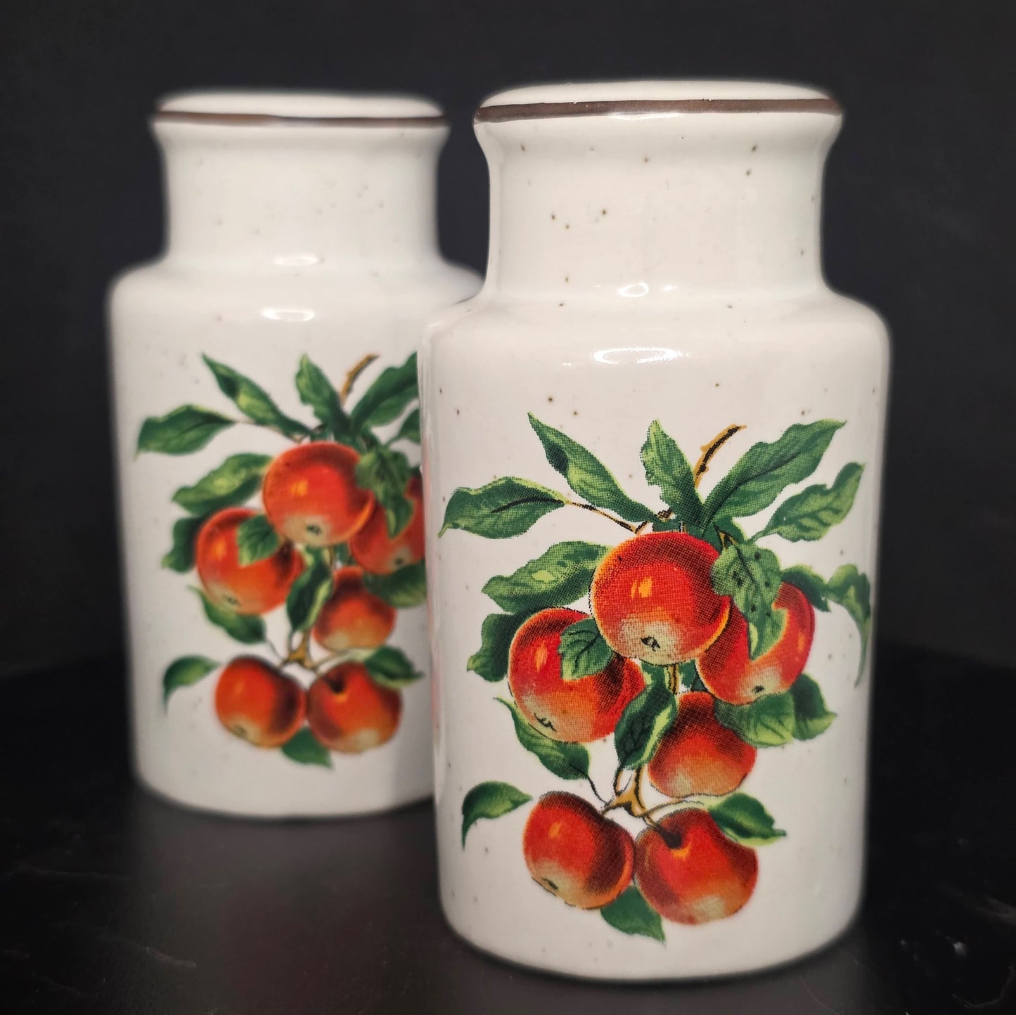 Front view of vintage Enesco apple shakers with stoppers