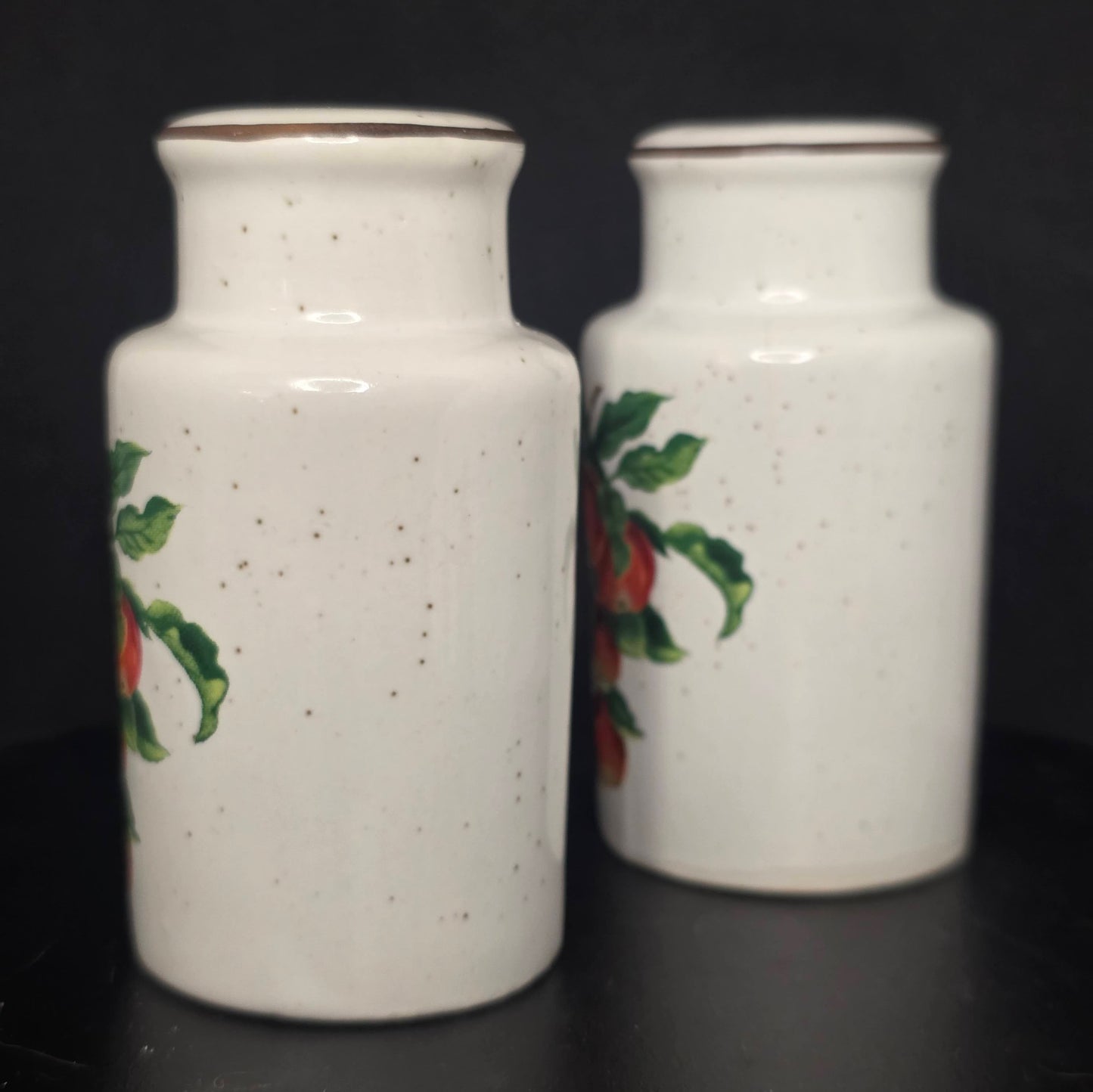 Side view of glazed ceramic apple shakers in excellent condition
