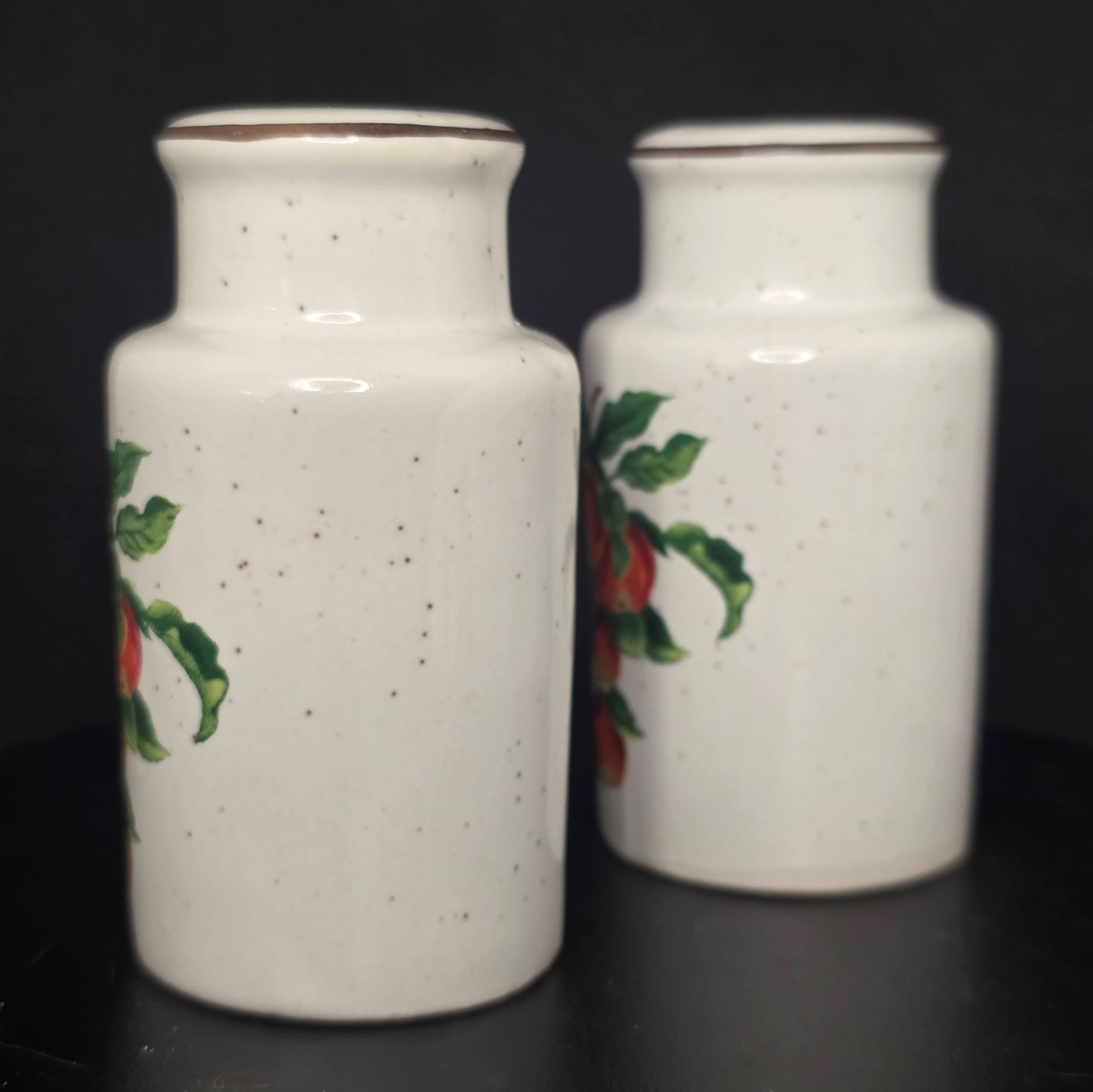 Side view of glazed ceramic apple shakers in excellent condition