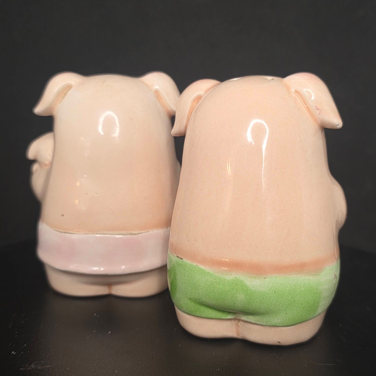 Back view of glazed ceramic pig shakers in excellent condition
