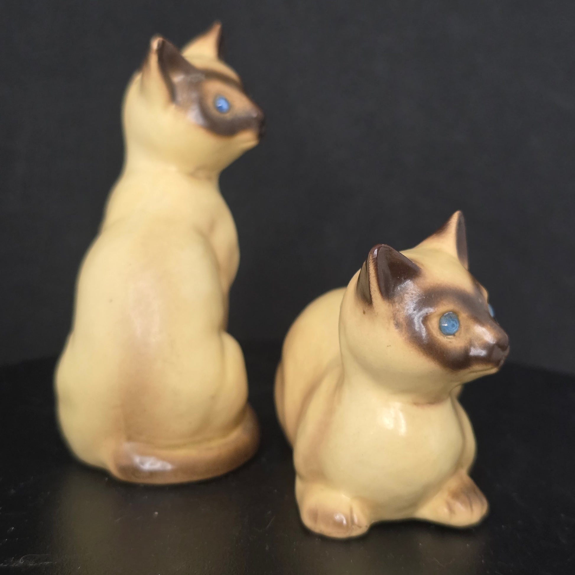 Detail of bejeweled eyes on vintage Siamese cat shakers with stoppers