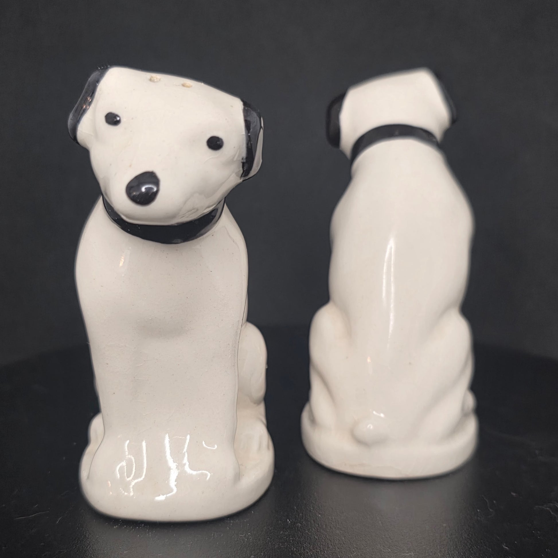Front view of iconic RCA Nipper white terrier mascot shakers with black ears