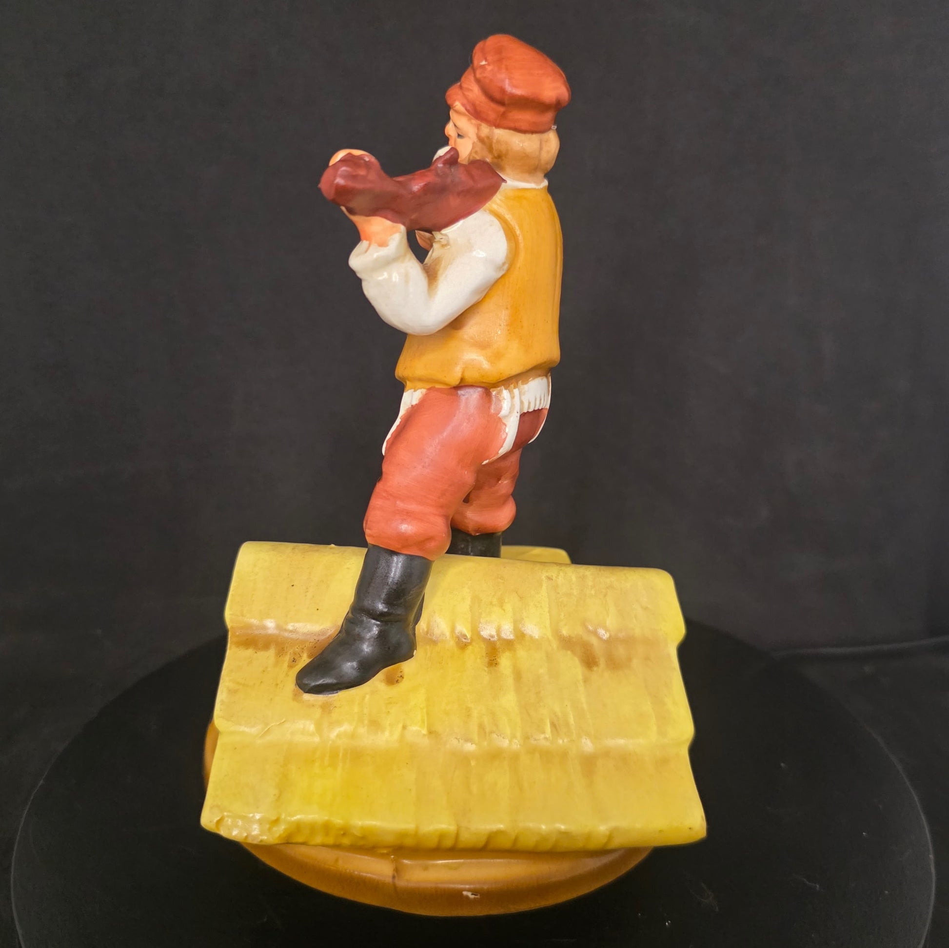 Side view of 1960s Broadway collectible musical figurine plays If I Were a Rich Man