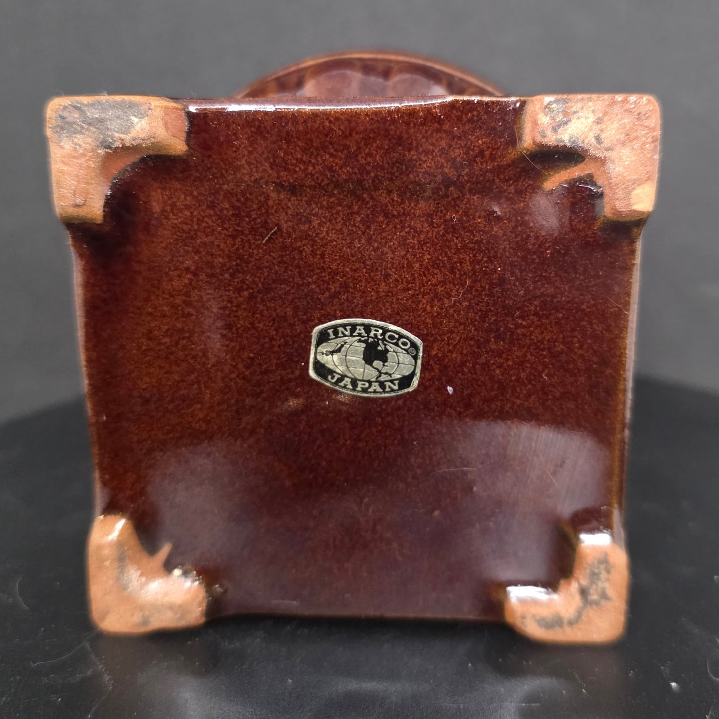 Close-up of Inarco Japan maker's mark on vintage ceramic pot belly stove utensil holder