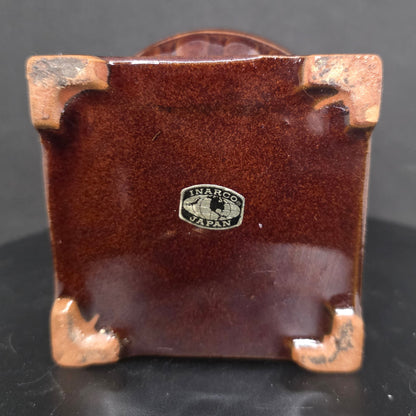 Close-up of Inarco Japan maker's mark on vintage ceramic pot belly stove utensil holder