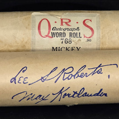 Vintage piano roll paper showing age patina and yellowing with stamped player signatures Lee S Roberts and Max Kortlander
