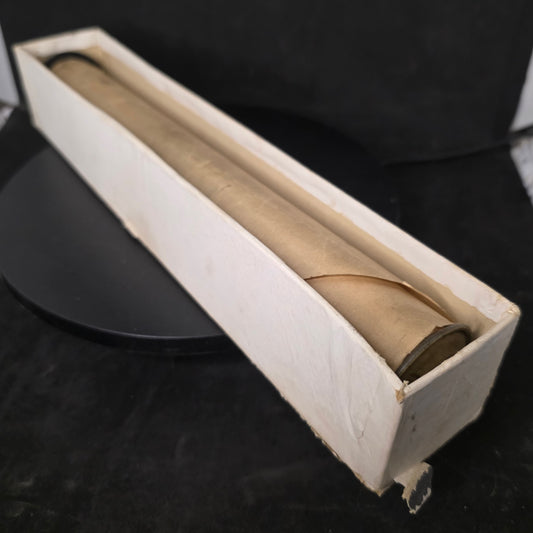 Vintage piano roll with unknown brand in original cardboard box bottom showing wear and age