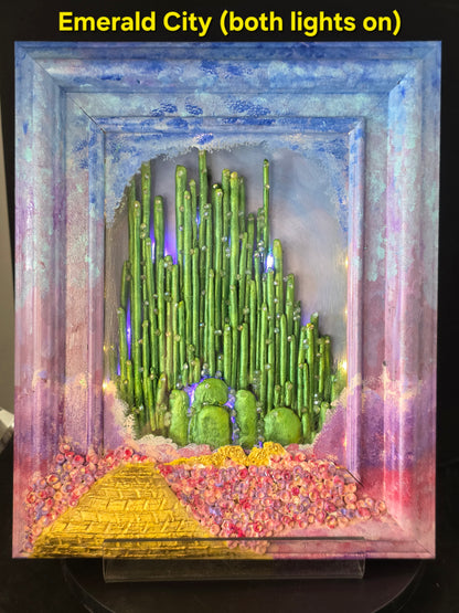 Wizard of Oz Emerald City shadow box with both warm white and purple fairy lights on, full illumination showing nightlight effect