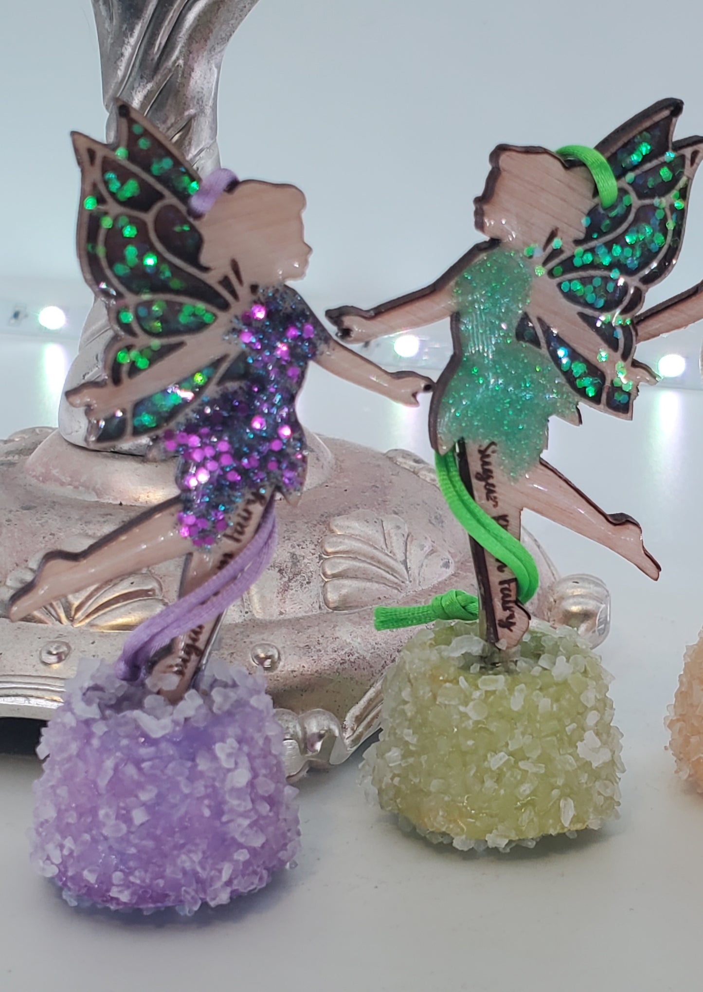 Decorative ornaments with a purple and green fairy design  on a light white background
