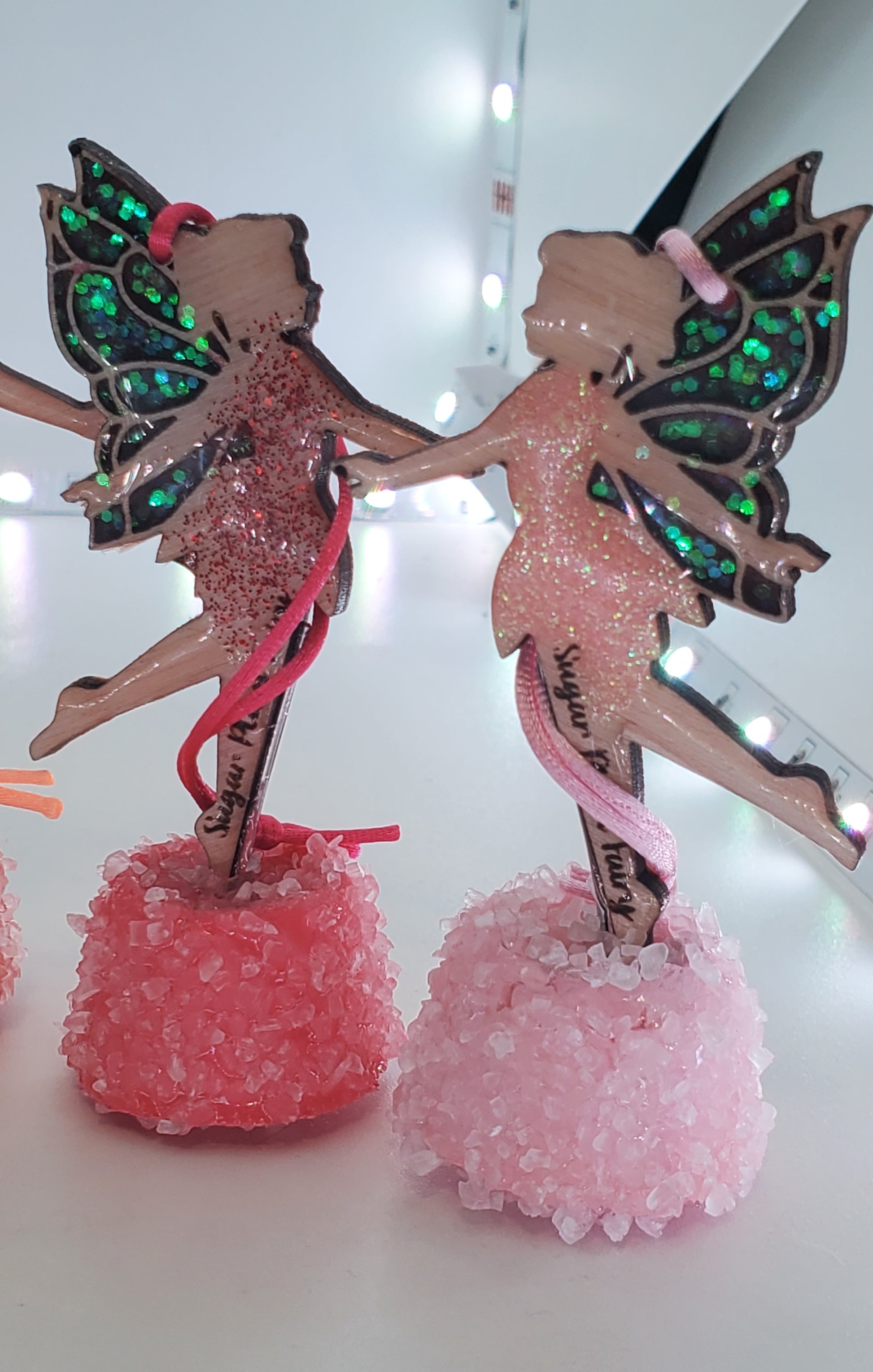 Decorative ornaments with a red and pink fairy design  on a light white background