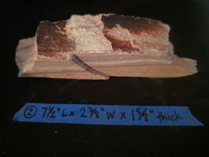 Rock sample with dimensions labeled on a dark background