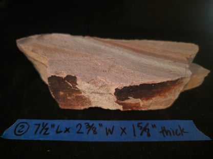 Sandstone sample with dimensions labeled on a dark background