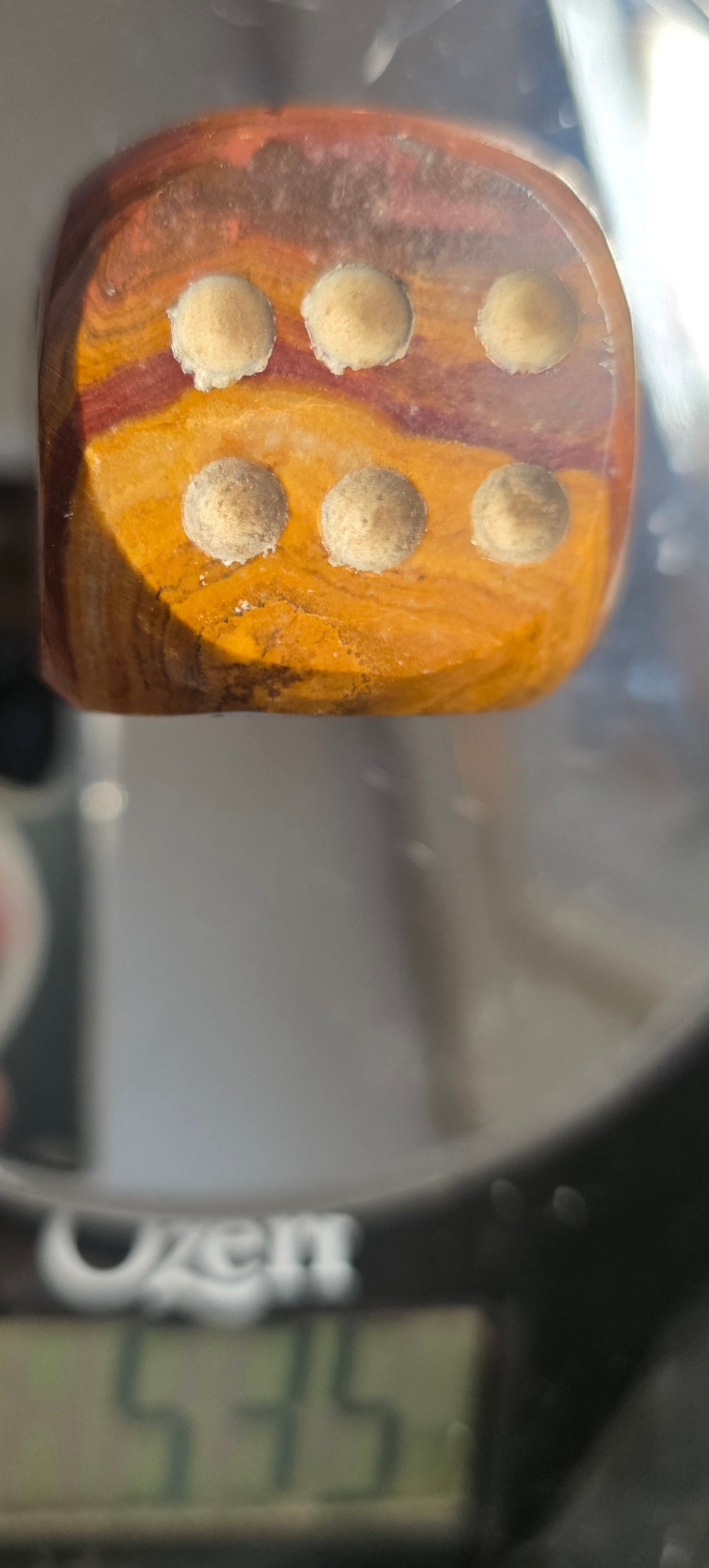 Onyx die with pips on a digital scale