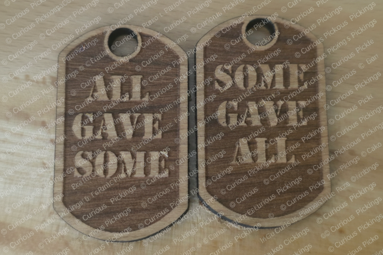 Two unfinished hardwood laser-cut military dog tags reading 'All Gave Some' and 'Some Gave All,' 1¾ inches long with a hanging hole, shown as a pair on a white background.